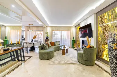a living room with couches and a tv at Luxury 2-Bedroom Apartment in Hivernage Pool Residence Near Casino in Marrakech