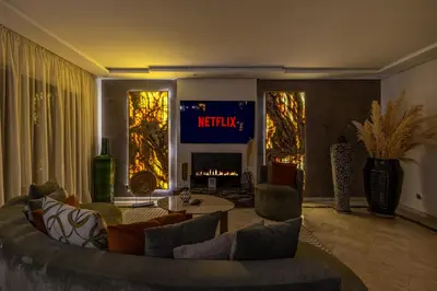 a living room with a couch and a fire place at Luxury 2-Bedroom Apartment in Hivernage Pool Residence Near Casino in Marrakech