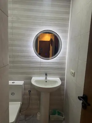 a bathroom with a sink and a mirror at Burj Malak appartement dans une résidence privée avec piscine in Marrakech