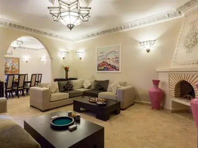 a living room with a couch and a fireplace at Riad Magda & Spa in Marrakech