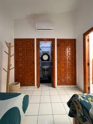 a bathroom with two doors and a toilet in a room at Riad Kinane Romann in Marrakech