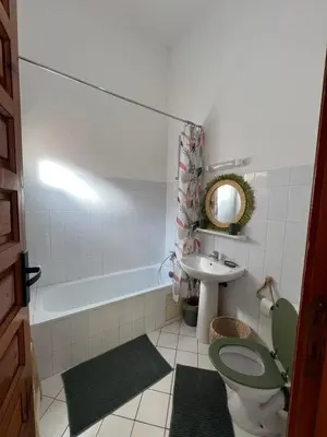 a bathroom with a green toilet and a sink at Riad Kinane Romann in Marrakech