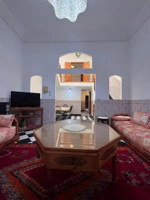 a living room with a couch and a coffee table at Riad Kinane Romann in Marrakech