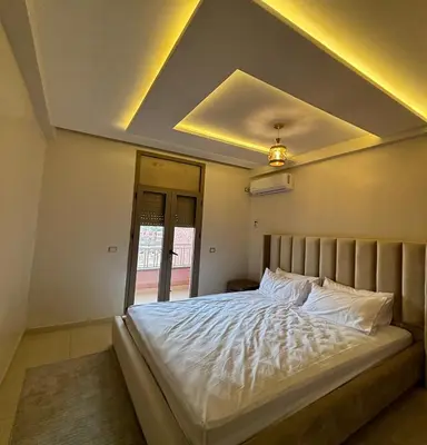 a bedroom with a large white bed with a ceiling at Retraite paisible à Gueliz in Marrakech