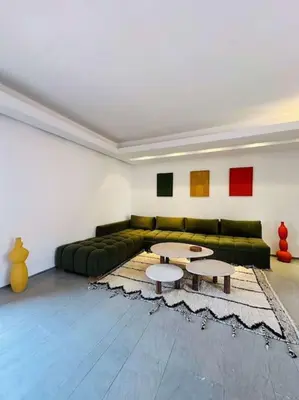 a living room with a green couch and two tables at Luxueux 1 Chambre Guéliz Centre in Marrakech