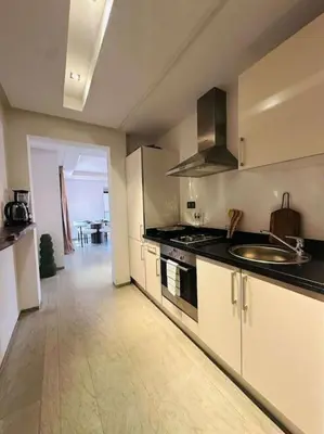 a kitchen with a sink and a stove top oven at Luxueux 1 Chambre Guéliz Centre in Marrakech