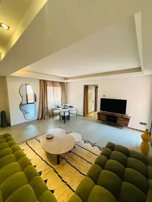 a living room with a couch and a table at Luxueux 1 Chambre Guéliz Centre in Marrakech