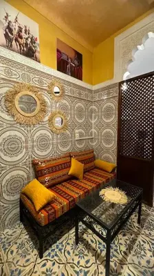 a living room with a couch and a table at Central Marrakesh Medina Apartment in Marrakech