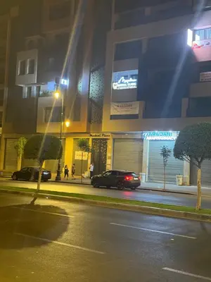 a car parked in front of a building at night at Luxueux Appartement-52 - Guéliz Marrakech in Marrakech