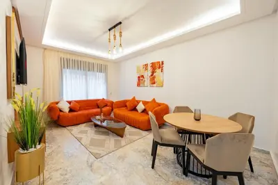 a living room with a couch and a table at Luxueux Appartement-52 - Guéliz Marrakech in Marrakech