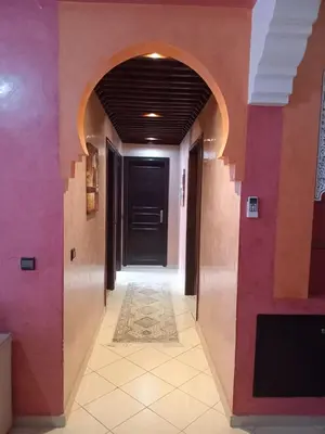 a hallway with a black door and purple walls at Superbe Appartement 2 chambres à AL FADL Marrakech in Marrakech