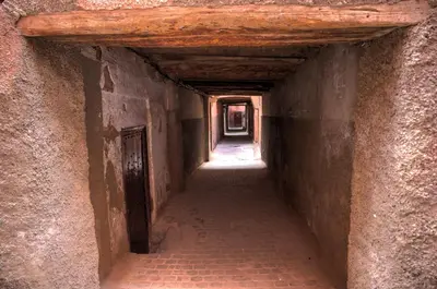 an alley way with a tunnel in an old building at Riad Chameleon in Marrakech