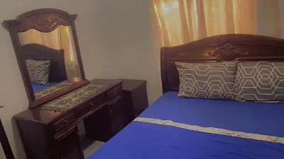 a bedroom with a bed and a dresser with a mirror at Mustapha in Marrakech