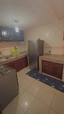 a kitchen with a stainless steel refrigerator and cabinets at Mustapha in Marrakech