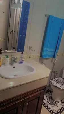 a bathroom with a sink and a toilet and a mirror at Mustapha in Marrakech
