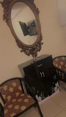 a mirror on a wall with a chair and a purse at Mustapha in Marrakech