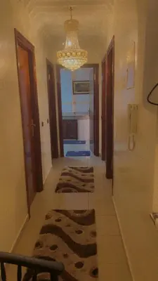 a hallway with several rugs on the floor in a house at Mustapha in Marrakech
