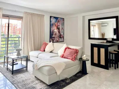 a living room with a white couch and a table at Fun-filled luxury city center apartment in Marrakech
