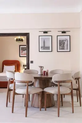 a room with a table and chairs and a bed at Merveille d'Art & Design - Marrakech Downtown in Marrakech