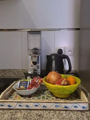 a kitchen counter with a bowl of fruit on a counter top at Top Appartement 1 Rue Yves Saint Laurent for 1-2 Per- Touristes International in Marrakech