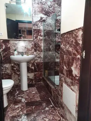 a bathroom with a sink and a toilet and a mirror at Top Appartement 1 Rue Yves Saint Laurent for 1-2 Per- Touristes International in Marrakech