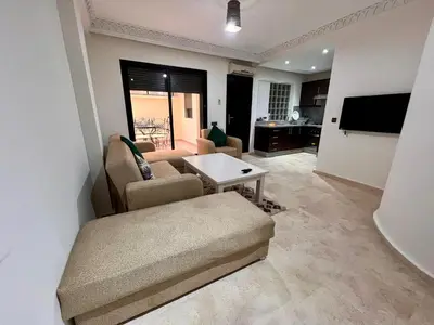 a living room with a couch and a table at Résidence Miramas 2 E1 in Marrakech