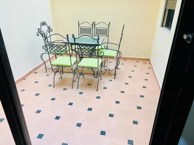 a table and chairs in a room with a tile floor at Résidence Miramas 2 E1 in Marrakech