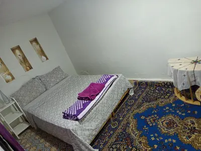 a small bedroom with a bed and a table at Riad Derb El Aarsa in Marrakech