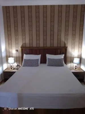 a bedroom with a large white bed with two night stands at Charming Two-Bedroom Apartment in Gueliz,Marrakesh in Marrakech