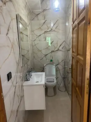 a bathroom with a white sink and a toilet at Charming Two-Bedroom Apartment in Gueliz,Marrakesh in Marrakech