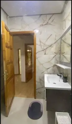 a bathroom with a sink and a stone wall at Charming Two-Bedroom Apartment in Gueliz,Marrakesh in Marrakech
