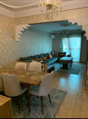 a dining room with a table and a couch at Charming Two-Bedroom Apartment in Gueliz,Marrakesh in Marrakech