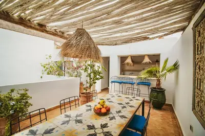 a dining room with a table with a bowl of fruit on it at RIAD Dar Argana 100m Place Jemaa el- Fna heated Pool in Marrakech