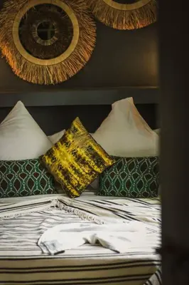 a bed with two pillows on top of it at RIAD Dar Argana 100m Place Jemaa el- Fna heated Pool in Marrakech