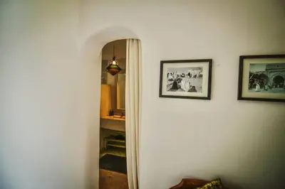 a hallway with two pictures hanging on a wall at RIAD Dar Argana 100m Place Jemaa el- Fna heated Pool in Marrakech