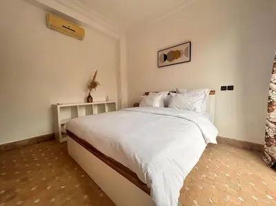 a bedroom with a large bed with white sheets and pillows at Villa Gioia et Luna Garden City-Services All-inConciergerie in Marrakech
