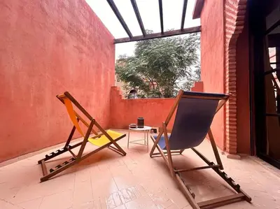 two chairs and a table in a room with a window at Villa Gioia et Luna Garden City-Services All-inConciergerie in Marrakech