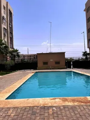 a large blue swimming pool in front of a building at Dar yahya in Marrakech