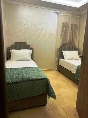 a bedroom with two beds in a room at Dar yahya in Marrakech