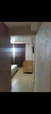an empty room with a bed and a window at Appartement au coeur de Marrakech avec deux piscines et une charmante vue in Marrakech