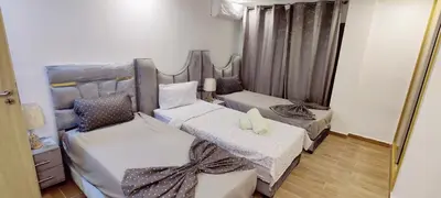 a bedroom with two beds and a mirror at Elégant duplex au coeur de Marrakech, Nakhil in Marrakech