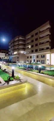 a city street at night with buildings in the background at Elégant duplex au coeur de Marrakech, Nakhil in Marrakech