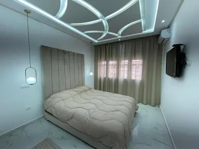 a bedroom with a bed and a tv in it at Centre de Guéliz in Marrakech