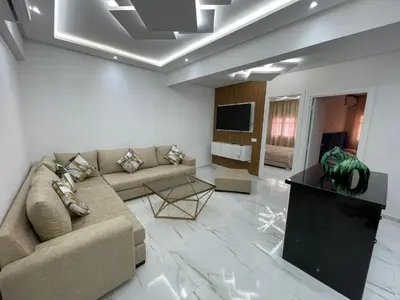 a living room with a couch and a tv at Centre de Guéliz in Marrakech
