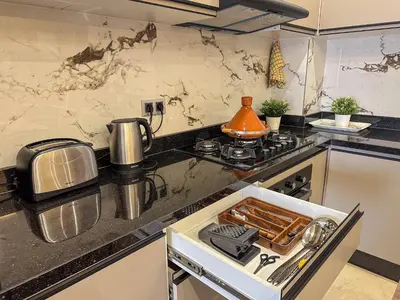 a kitchen with a stove and a counter top at Appartement neuf 1 Ch - 5 min de la gare in Marrakech