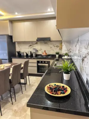 a plate of food on a counter in a kitchen at Appartement neuf 1 Ch - 5 min de la gare in Marrakech
