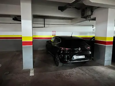 a black car parked in a parking garage at Appartement neuf 1 Ch - 5 min de la gare in Marrakech