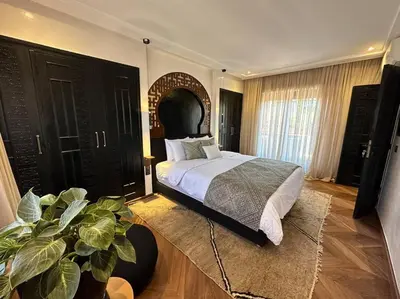 a bedroom with a large bed and a potted plant at Roof top terrasse Centre-Gueliz JACUZZI in Marrakech