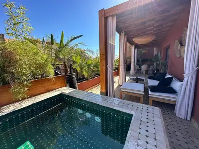a swimming pool in front of a house at Roof top terrasse Centre-Gueliz JACUZZI in Marrakech