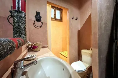 a bathroom with a sink and a toilet at DAR SMAWAR top piscine chauffée 15mn centre ville in El Caïd Omar